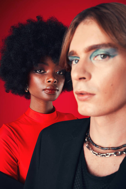 Makeup, beauty and portrait of people with diversity in fashion on red background in studio with creative, LGBT or style. Unique, aesthetic and cosmetics with gen z black woman and gay man model. - Foto, Bild