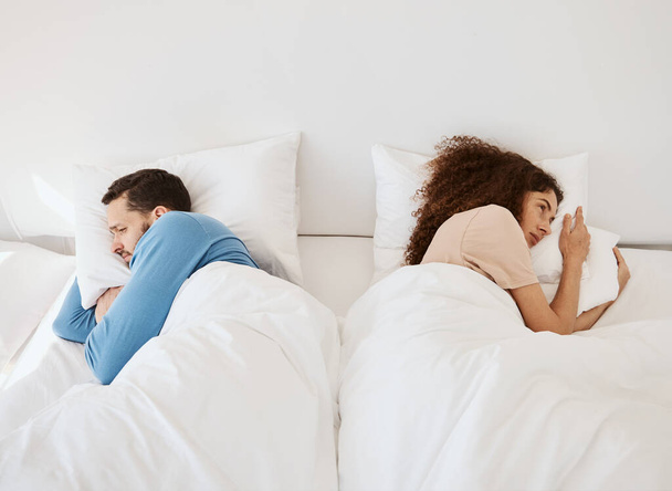 Divorce, ignore and angry couple in bed after fight, argument or dispute in their home from above. Marriage, stress and top view of frustrated man and woman in a bedroom with crisis, fail or conflict. - Photo, Image