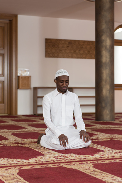 African Muslim Man Praying At Mosque - 写真・画像