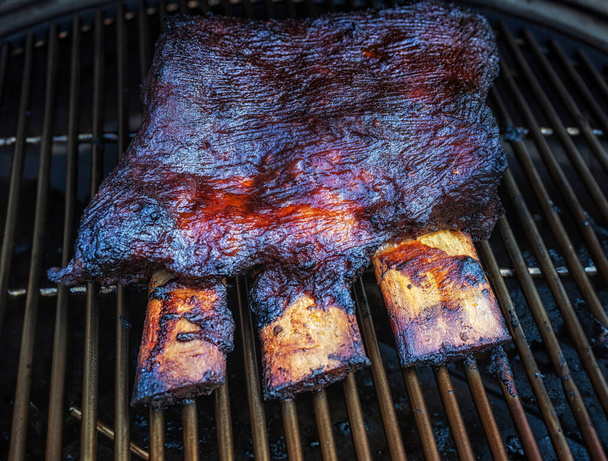 Barbecue burnt chuck beef ribs marinated and sliced with hot chili sauce as top view - Photo, Image