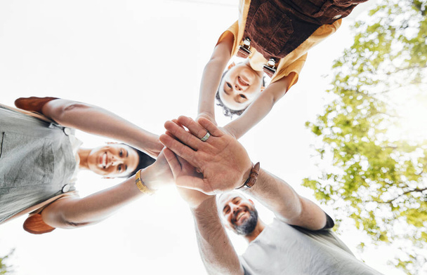 Low, friends and portrait with hands stacked in nature for motivation, team building and success. Happy, together and group of people with a gesture for support, teamwork or community in a park. - Фото, изображение