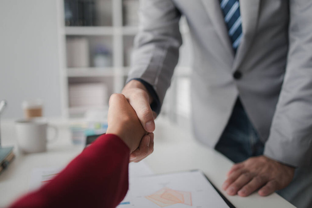 Two investors are shaking hands, business venture capitalists open a startup company together and shake hands after discussing a contract signing. Business investment concept. - Photo, Image