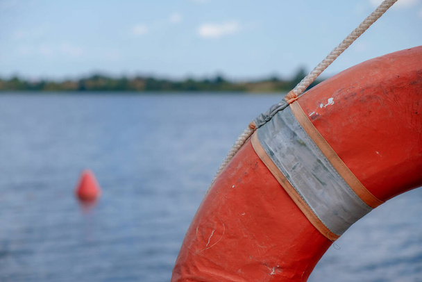 Lifebuoy or safety wheel on water background. - Photo, Image