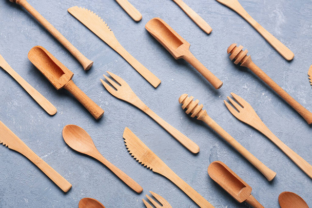 Different wooden kitchen utensils on blue background - Photo, Image