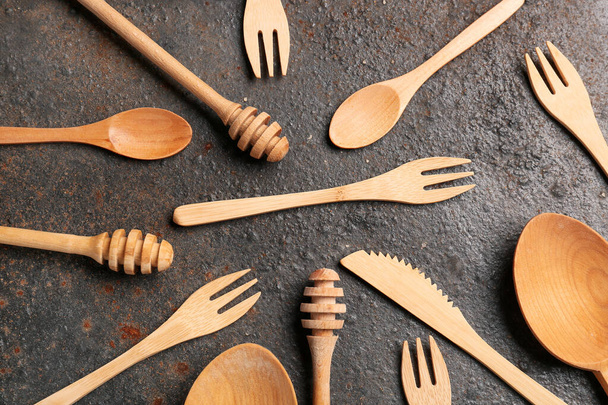 Different wooden kitchen utensils on brown background - Photo, Image