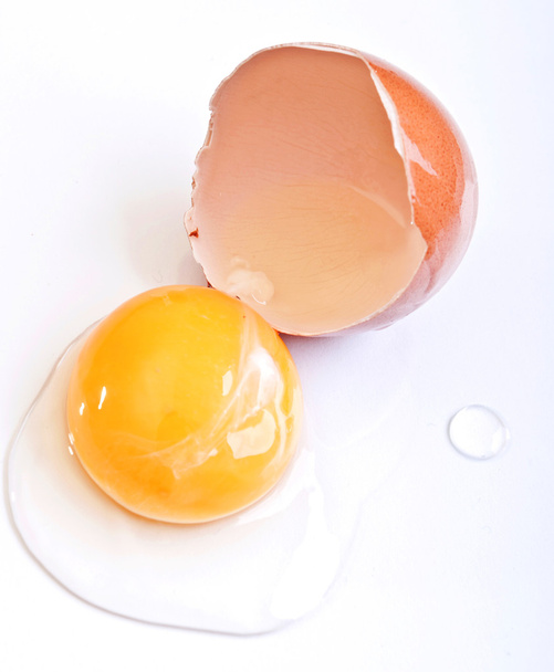 Brown eggs on a white background.  egg is broken. - Photo, Image