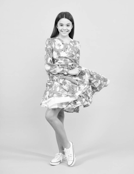 Full length of teenager child wearing summer dress. Happy teenager, positive and smiling emotions. Movement dress of young child teen girl - Foto, Bild