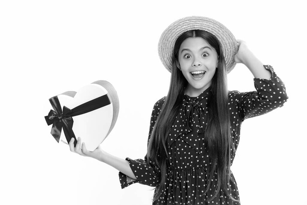 Summer kids sale. Emotional teenager child hold gift on birthday. Funny kid girl holding gift boxes celebrating happy New Year or Christmas. Portrait of emotional amazed excited teen girl - Photo, image