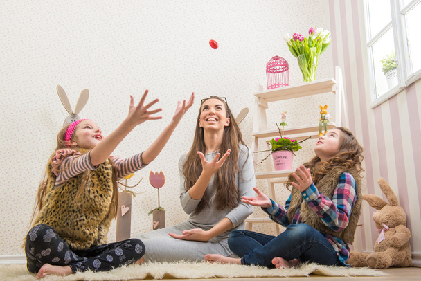 Mother and daughters thrown chocolate eggs - Фото, зображення