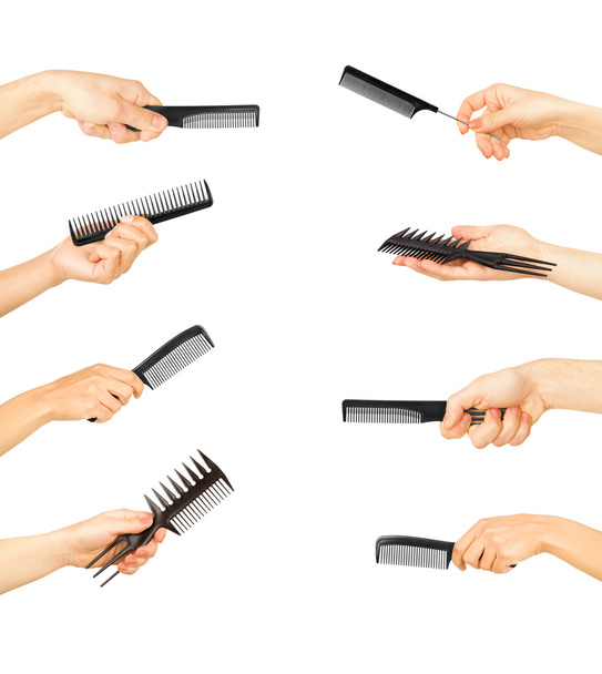 Hands holding combs and brushes on a white background - Фото, изображение