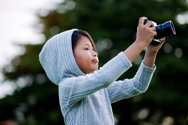 Fényképezz tükör nélküli kamerával. Kislány gyakorló természet fotózás kis fotós az öröm, hogy képeket - Fotó, kép