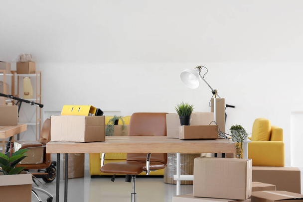 Interior of office with cardboard boxes on moving day - Photo, Image