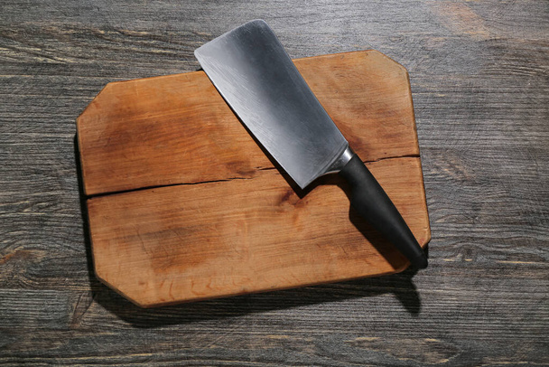 New cutting board and meat cleaver on wooden background - Photo, Image