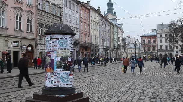 LVIV, UKRAINE - February 28, 2015 Lviv central square busy with pedestrians walking and tram riding - Materiał filmowy, wideo
