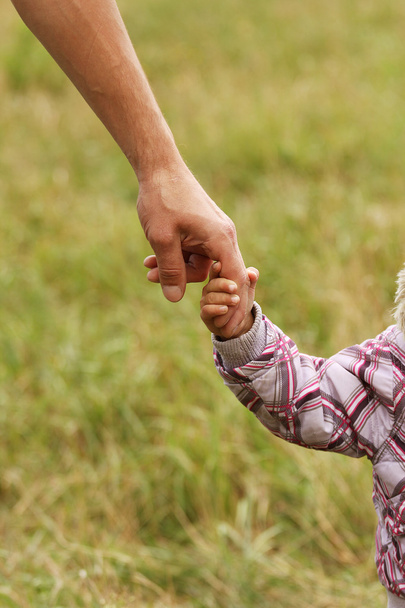 Parent holds hand of child - Foto, Bild