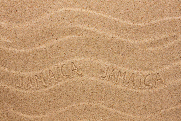 Jamaica  inscription on the wavy sand - Fotografie, Obrázek