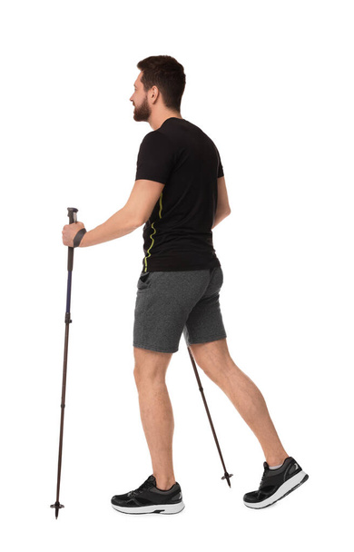 Man practicing Nordic walking with poles isolated on white - Foto, Imagen