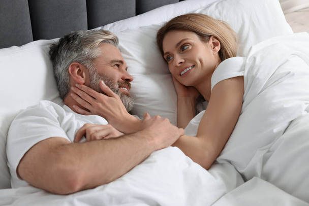 Lovely mature couple in bed at home - Valokuva, kuva