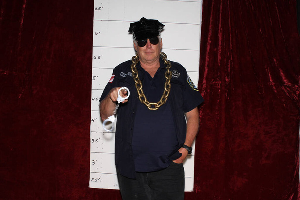 A man in a Police Uniform poses for his Mug Shot. - Photo, Image
