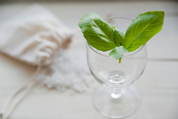 Fresh green basil in glass with sea salt on background - Zdjęcie, obraz