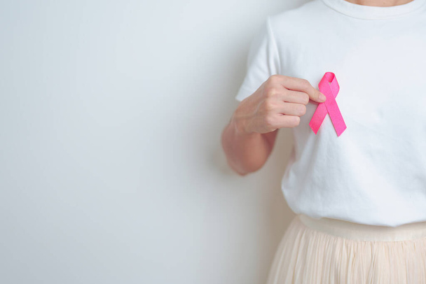 Pink October Breast Cancer Awareness month, woman with pink Ribbon in hospital for support people life and illness. National cancer survivors month, Mother and World cancer day concept - Photo, Image