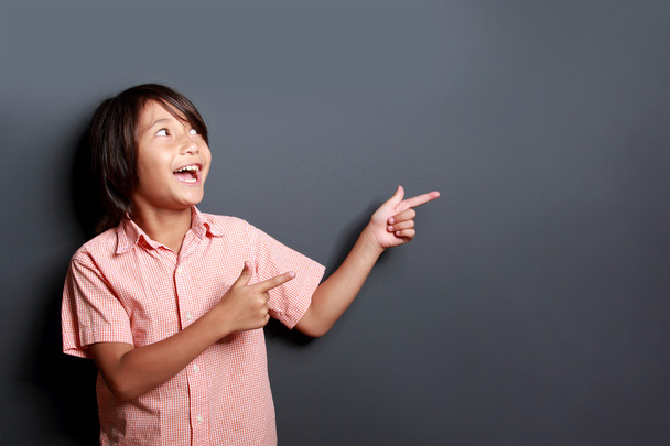 little boy laughing and pointing at copy space - Foto, Imagen