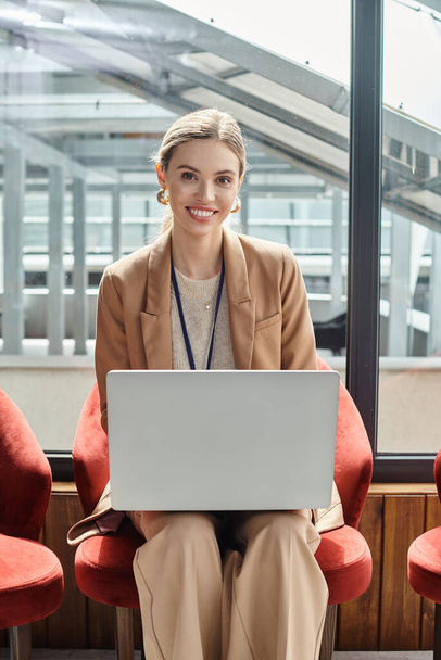 close up young woman in smart suit working on her laptop looking at camera, coworking concept - Photo, Image