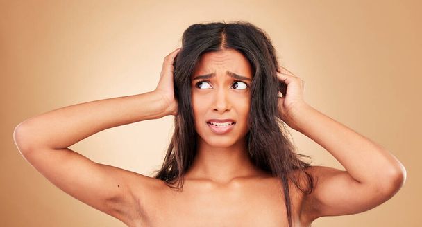 Hair loss, stress and woman with crisis, disaster and hairdresser fail in studio on brown background. Natural, frustration and shocked person, messy and tangled treatment for haircare and girl. - Photo, Image