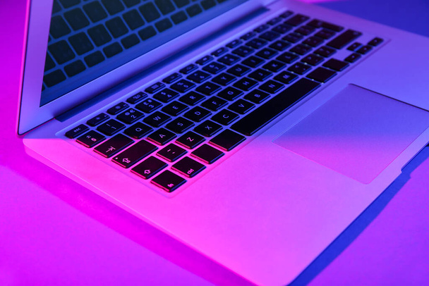 Modern laptop on purple background - Photo, Image