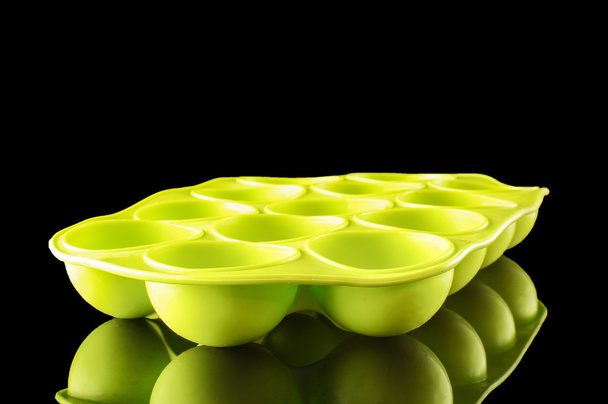Green silicone ice cube tray isolated with copy space - Photo, Image