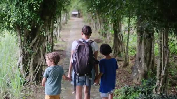 мама с рюкзаком гуляет по джунглям с детьми - Кадры, видео