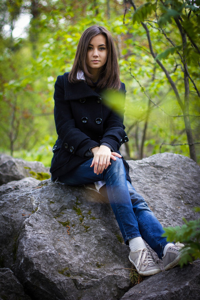 cute girl sitting on a rock - Foto, Imagem