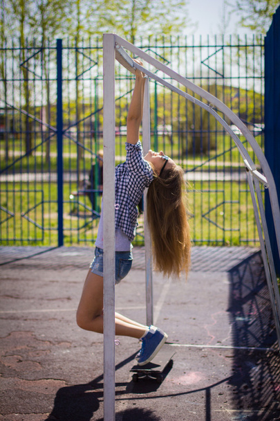 cute girl in shorts with a skateboard on the Playground - Фото, зображення