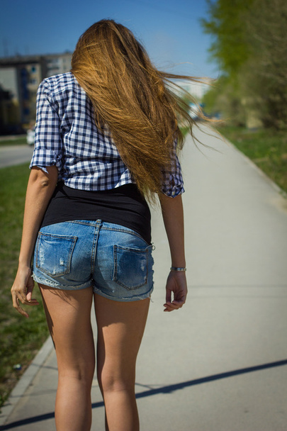 girl in shorts riding a skateboard - 写真・画像