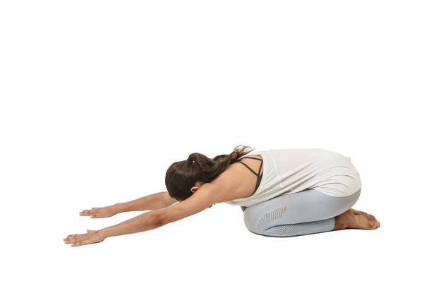 woman practicing yoga, Balasana position or child's pose on a white background - Photo, Image