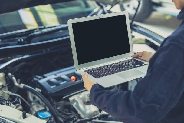 laptop computer blank screen with modern car engine performance ECU tune up in auto garage workshop concept - Photo, Image