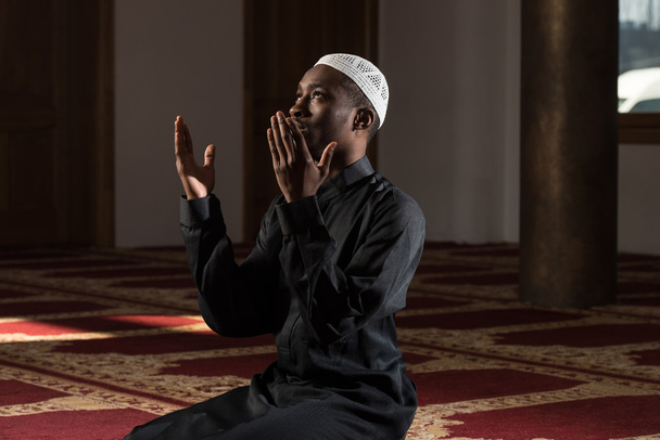 African Muslim Man Praying At Mosque - Photo, image