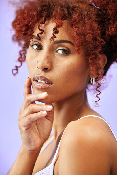 Stüdyoda portre ve cilt bakımlı bir kadın, kırmızı bukleler ve mor arka planda makyajlı dermatoloji. Saç bakımı, yüz ve kozmetik ürünleri ve Brezilya modelli kıvırcık saç stili.. - Fotoğraf, Görsel