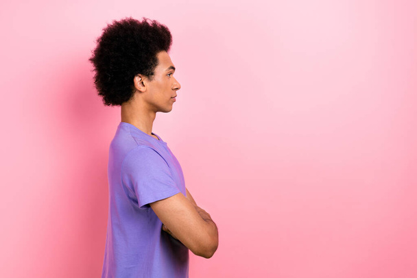 Side profile photo of serious guy with perming coiffure wear t-shirt look empty space arms crossed isolated on pink color background. - Фото, зображення