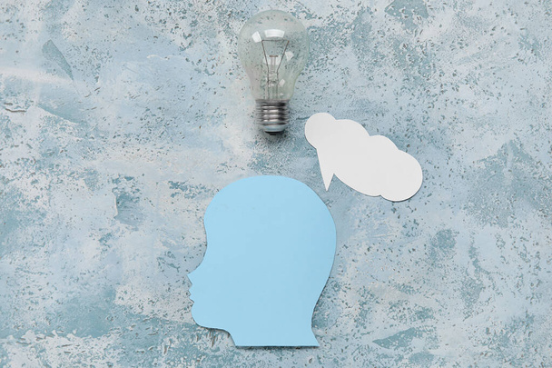 Paper human head with speech bubble and light bulb on grunge background. Logic concept - Photo, Image