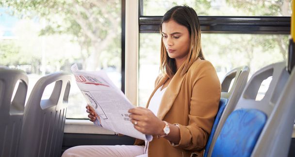 Woman on a bus, transportation and travel with newspaper, commute to work or university, city and traffic. Transportation, vehicle and student, trip and reading material with metro and public service. - Photo, Image