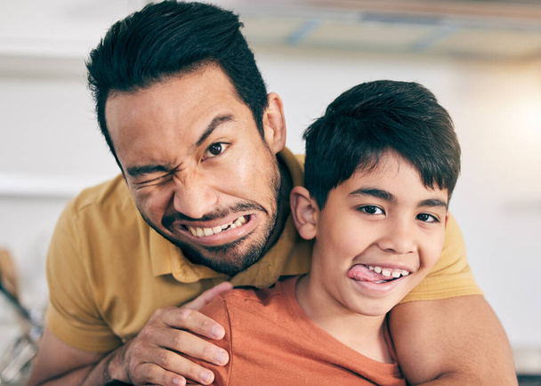 Funny, face and dad with child in home together with crazy comedy, joke or bonding on vacation, weekend or holiday, Silly, father and son in portrait with goofy expression or family humor in house. - Photo, Image
