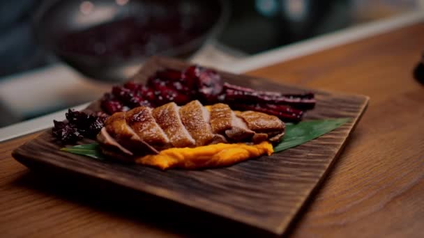 close-up of a dish pieces of juicy roasted duck with puree on plate Asian cuisine restaurant - Footage, Video