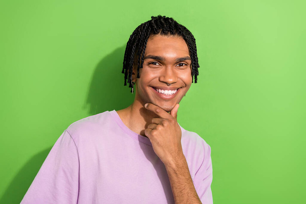 Photo of confident smart man dressed purple t-shirt arm chin smiling isolated green color background. - Zdjęcie, obraz