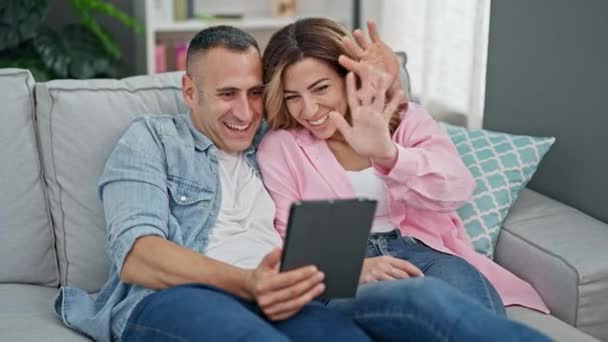 Man and woman couple having video call sitting on sofa at home - Video