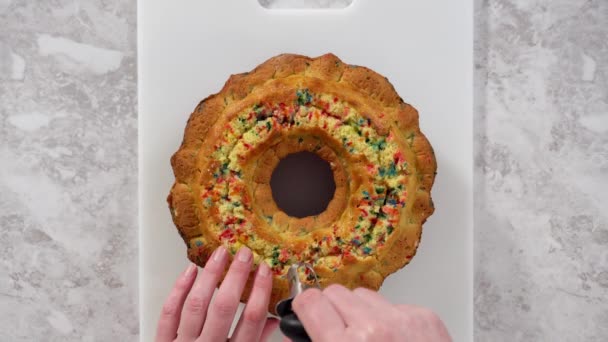 Flat lay. Creating holes for the buttercream filling in funfettti bundt cake. - Footage, Video