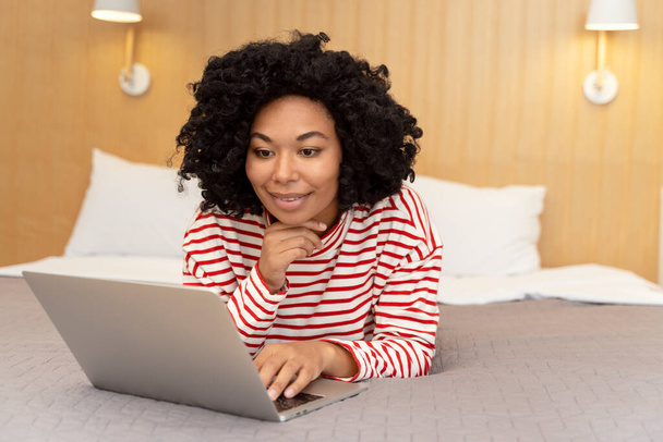 Beautiful smiling African American woman using laptop computer working online from home - Photo, image