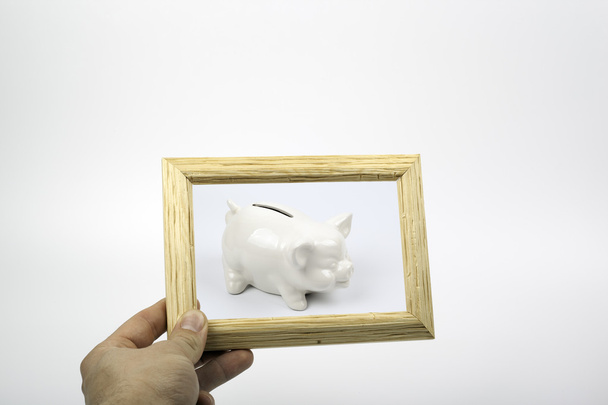 Piggy bank and a wooden texture frame - Foto, Bild