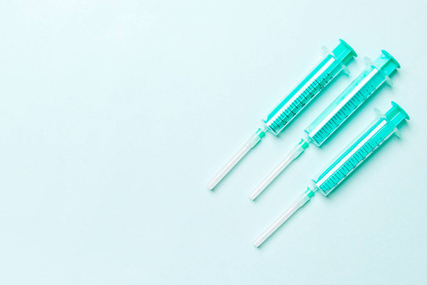 Top view of medical syringes on colorful background with copy space. Injection equipment concept. - Photo, Image