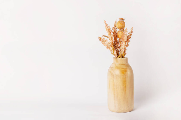 Autumn decor dried flowers in yellow wooden vase on white background. copy space - Photo, Image
